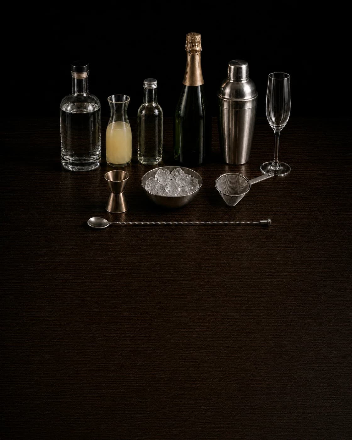 Overhead French 75 station arranged on a dark walnut bar