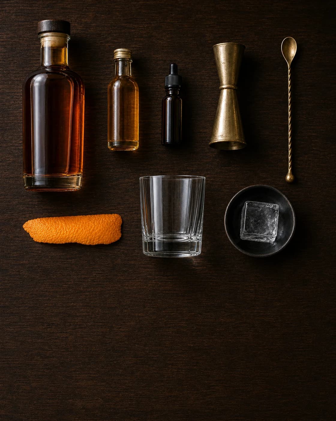 Overhead Old Fashioned station arranged on a dark walnut bar