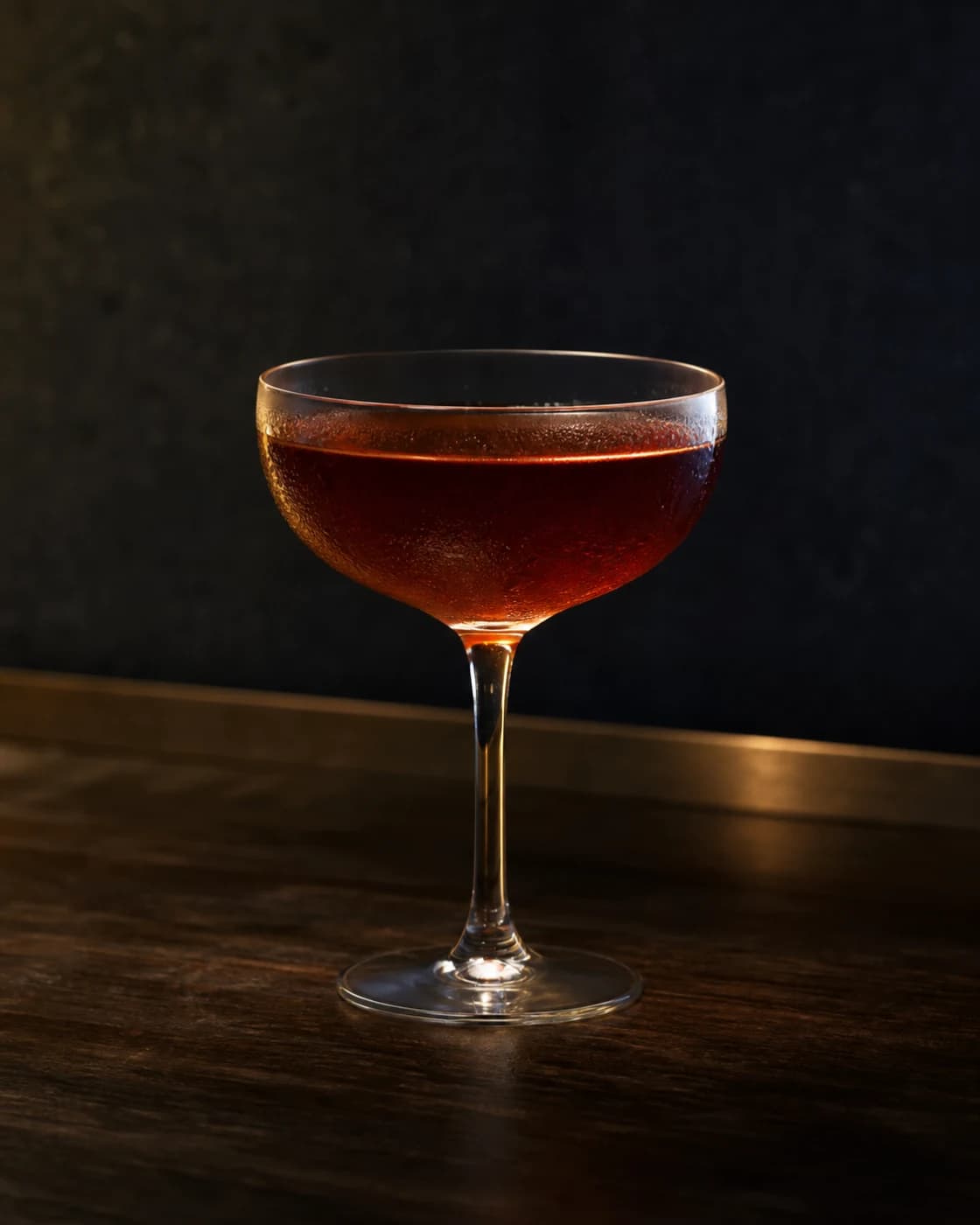 Add the cherry stage with dark red cocktail cherry on a brass cocktail pick