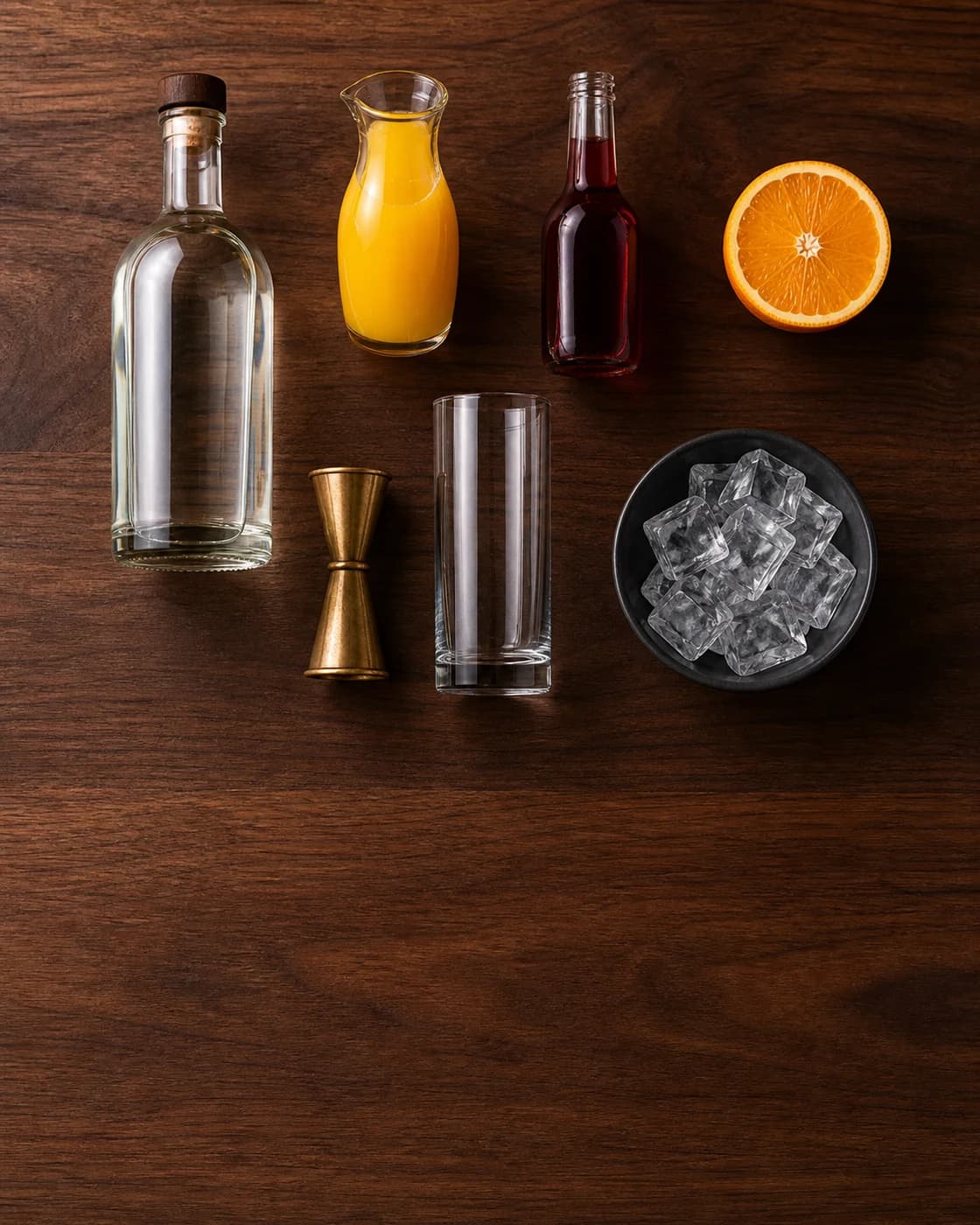 Overhead Tequila Sunrise station arranged on a dark walnut bar
